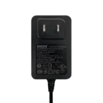 Black electrical power adapter with specifications label.