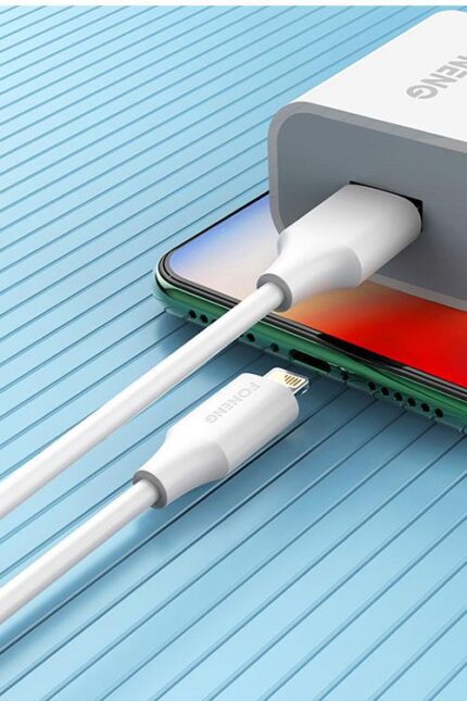 Smartphone charging with white USB cable.