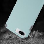 A mint green smartphone case with reinforced corners, shown on a dark background.