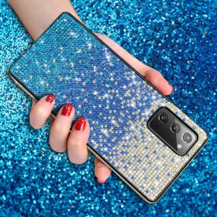Hand holding a glittery blue phone case.