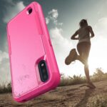 A pink phone case with a runner in the background.