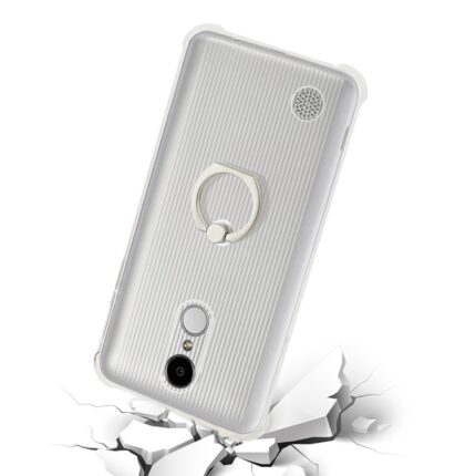 White smartphone with a ring holder on the back, shown cracked on the surface beneath.