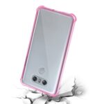 Smartphone with a pink protective case on cracked surface.