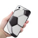 Hand holding a phone case designed like a soccer ball.