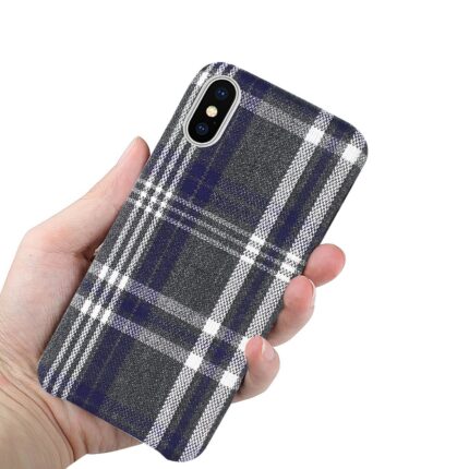 Hand holding a phone with a blue plaid case.