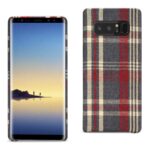 Smartphone with a scenic wallpaper and plaid fabric back cover.