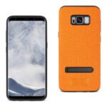 Smartphone with a cloudy sky wallpaper and an orange fabric case.