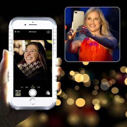 Woman taking a selfie at night with a bright city lights background.