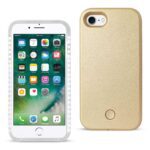 White iPhone with a gold protective case beside it.