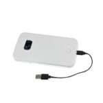 A white portable power bank with a connected charging cable.