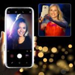 Two women taking selfies with smartphones, one in close-up and another in an inset photo.