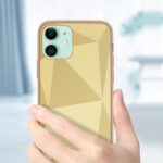 Hand holding a smartphone with a geometric-patterned yellow case.