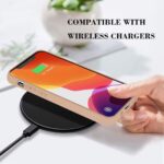 Smartphone charging wirelessly on a sleek black pad.