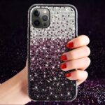 Hand holding a glittery phone case with ombre sparkles.