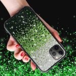 Hand holding a sparkling green and silver rhinestone phone case.