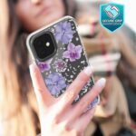 Person holding a phone with a floral phone case.
