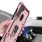 Hand holding a rugged pink phone case with magnetic ring and kickstand.