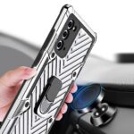 Hand holding a phone with a rugged case and ring grip.