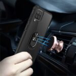 Magnetic phone holder attached to a car vent with a phone case featuring a ring grip.