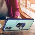 Person holding a phone with a ring holder on the back.