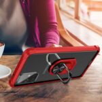 Person using smartphone with a red case and ring stand at a wooden table.