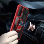 A hand holds a red phone case with a ring holder inside a car.