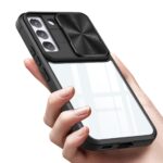 Person holding a smartphone with a protective case featuring a camera cover and a clear back.
